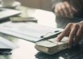 businessman-puts-forward-money-invest-buy-purchase-news