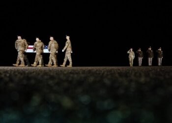 An Army carry team moves the flag-draped transfer case containing the remains of U.S. Army soldier Maj. Sorffly Davius, of Cambria Heights, N.Y., who died in Kuwait, during a casualty return, Monday, March 9, 2026, at Dover Air Force Base, Del. (AP Photo/Julia Demaree Nikhinson)