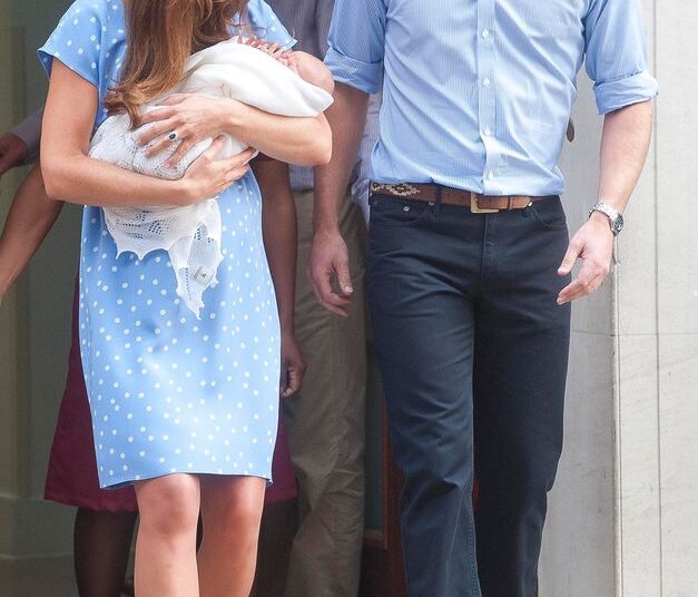 Kate Middleton carrying a baby Prince George and walking with Prince William