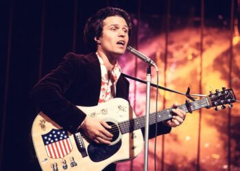 country joe mcdonald playing the guitar