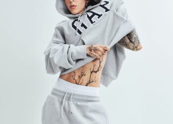 individual adjusting a gray hoodie and sweatpants