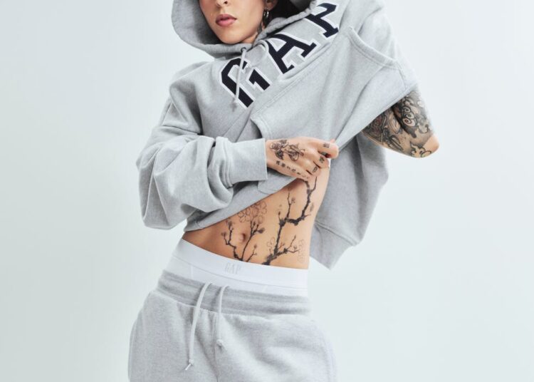 individual adjusting a gray hoodie and sweatpants
