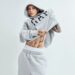 individual adjusting a gray hoodie and sweatpants