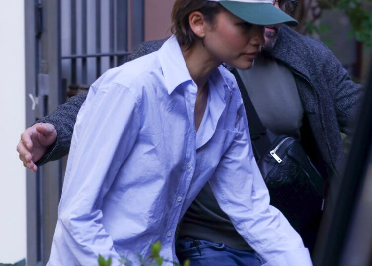 Two individuals leaving a building.