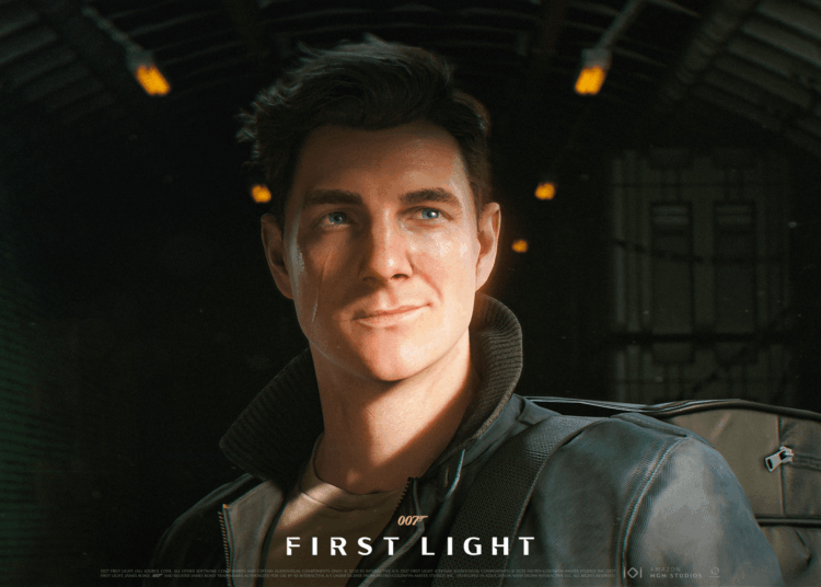 Close-up of a young man with short brown hair and a slight smile, wearing a leather jacket and backpack, set against a dimly lit background.