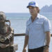 Jeff Probst standing in front of ocean next to woman, Savannah Louie, who is covered in mud in Survivor