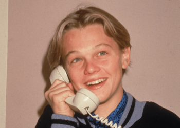 A young Leonardo DiCaprio poses for a picture while talking on a telephone, circa 1989 -