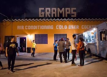 Photo of the outside of a local venue with orange walls and a sign that reads Gramps.