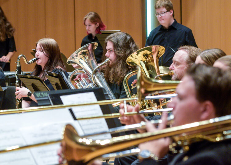 VCSU students play brass instruments during a rehearsal