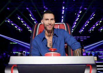 Adam Levine sitting and smiling in his judging chair on The Voice Season 29 Episode 2.