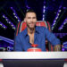 Adam Levine sitting and smiling in his judging chair on The Voice Season 29 Episode 2.