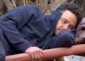 Adam Thomas lying on a camp bed on I'm A Celebrity