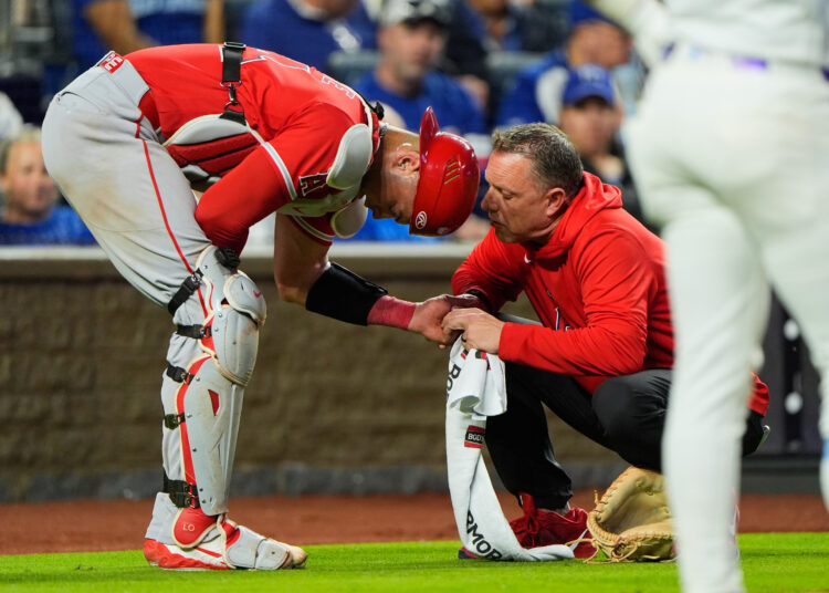 Angels catcher Logan O’Hoppe is tended to after getting injured...