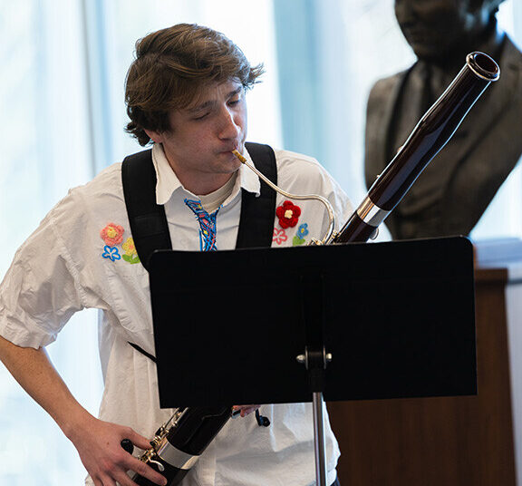 Comet Smith, a junior studying music composition, plays a bassoon solo written by Kathryn Hardgrave, a graduate student studying music composition. The composition was inspired by an item in the library's Archives and Special Collections – Hardgrave's item was a series of photographs of the Sand Hills by James Ducey.