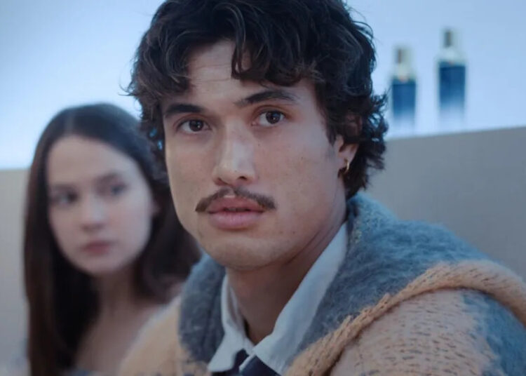 Austin (Charles Melton) looks ahead, as Ashley (Cailee Spaeney) looks to the side on Beef.