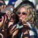 Sydney Sweeney takes photos with the front row fans just before BigXthePlug performed on the Mustang Stage during the Stagecoach Festival in Indio, Calif., April 24, 2026.