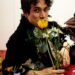 Person holding flowers while resting on a textured surface