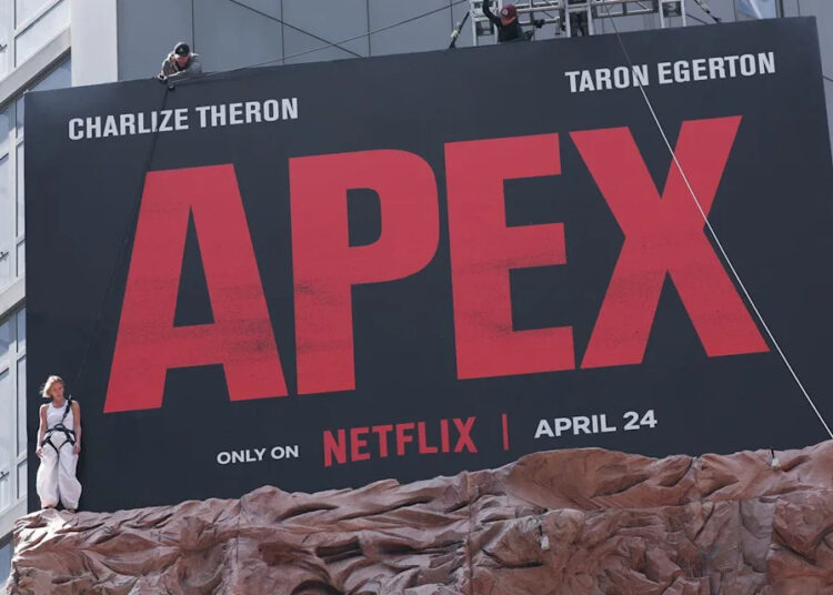 Charlize Thereon stands beside 'Apex' billboard in Times SquareCredit: Aeon/GC Images