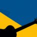 A striking abstract composition of jagged, geometric shapes in deep blue and bright yellow, conveying the idea of preserving the legacy of country music while championing its future.
