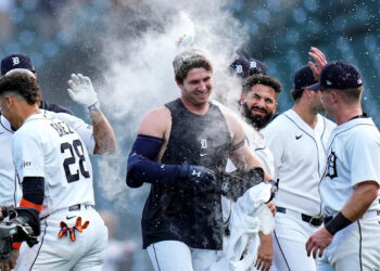 Detroit Tigers second baseman Colt Keith (33), center, is congratulated by teammates after batting a walk-off single against Kansas City Royals to win the game 10-9 at Comerica Park in Detroit on Thursday, April 16, 2026.