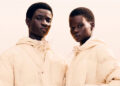Two models wearing matching light-colored puffer jackets, posing against a neutral background.