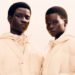 Two models wearing matching light-colored puffer jackets, posing against a neutral background.