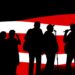 A dynamic abstract illustration featuring bold black shapes and bright red and white colors, conceptually representing the energy and patriotic spirit of Foley's community Music and Movie series.