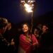 A Kurdish woman in traditional dress holds a lit torch during Nowruz, the Persian New Year, on a hill overlooking the town of Akra in the autonomous Kurdistan Region of Iraq, Friday, March 20, 2026. (AP Photo/Leo Correa)