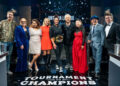 Host Guy Fieri and winning contestant Antonia Lofaso with Hunter Fieri, Tiffani Faison, Maneet Chauhan, Brooke Williamson, Mei Lin, Simon Majumdar, and Justin Warner, as seen on Tournament of Champions, Season 6, Food Network, 2025.