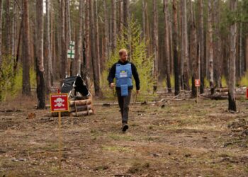 Britain's Prince Harry, the Duke of Sussex, walks in a forest as he visits members of the HALO Trust (Hazardous Area Life-support Organization), a non-commercial charity organisation for demining
