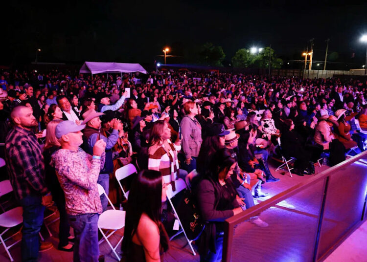Fans stand and watch as La Mafia performs at Longhorn Ballroom’s new Backyard Amphitheater, Saturday, March 28, 2026, in Dallas. (Elías Valverde II/Staff Photographer)