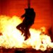 Contestants near flames during an episode of "Fear Factor"
