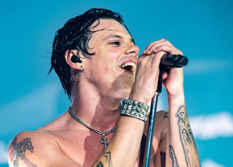 Yungblud singing on stage in Birmingham