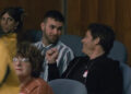 Ronald and James Marsden sitting together in Jury Duty.