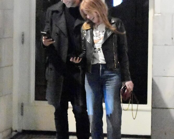 Isla Fisher getting cosy with former South African footballer Larry Cohen.