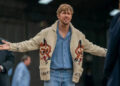 Ryan Gosling in his Fox sweater with his arms out wide in Project Hail Mary