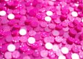 An abstract close-up photograph of shimmering, glittering pink sequins, representing the glamorous aesthetic of KATSEYE's new single 'Pinky Up'.