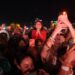 Fans hold up phones during a set at Coachella.