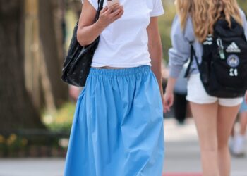 04152026 katie holmes puts on a colorful display while stepping out in new york city the american actress carried an apc tote bag and wore a white cropped t shirt, blue and red rosie assoulin skirt, and black horsebit loafers salestheimagedirectcom please bylinetheimagedirectcom