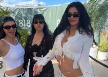 Group of three women posing together outdoors.