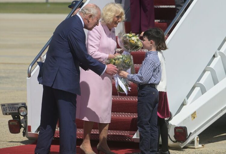 King Charles III and Queen Camilla receive posies from the children of British military families based in the United States, at Joint Base Andrews, Md., Monday, April 27, 2026. They are in the U.S. for a four-day state visit aimed at celebrating the United States' 250th anniversary, including a White House state dinner and a speech to Congress. (AP Photo/Rod Lamkey, Jr.)