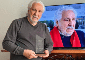 Santi Visalli holds his award from the American Photography Archives Group. (Courtesy photo)