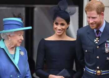 Queen Elizabeth II, Meghan Markle and Prince Harry watch the RAF100 flypast in 2018. By: James Whatling/MEGA