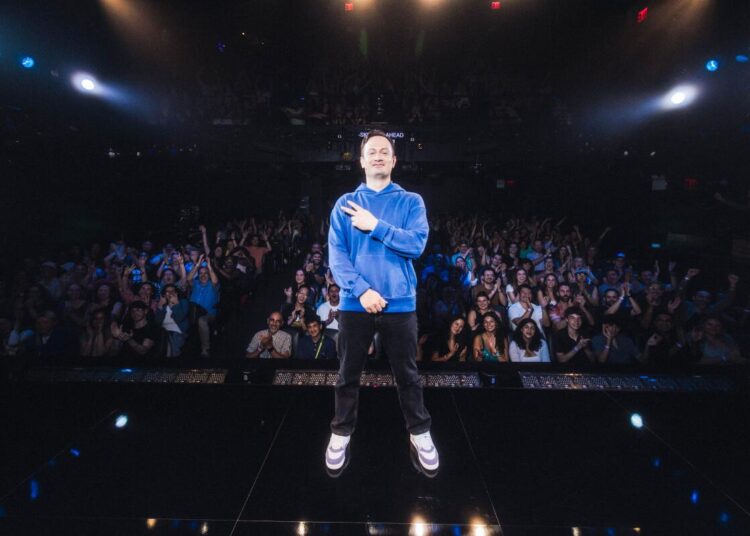 Michael Cruz Kayne stands onstage.