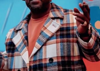 Rapper Jamel Davis (Sinthoro Upper) in a plaid coat and cap.