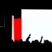 An abstract, minimalist illustration featuring bold, jagged shapes in red, white, and black, conceptually representing the variety of live events and entertainment experiences available in New Hampshire this spring.