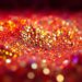 An extreme close-up image of shimmering, glittering textures in high-contrast studio lighting, conveying the glamour and energy of the indie music scene through an abstract, conceptual visual metaphor.