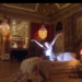 Luxurious room with a bed and a person gesturing dramatically.