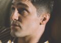 portrait of a person with a blurred face wearing a striped shirt