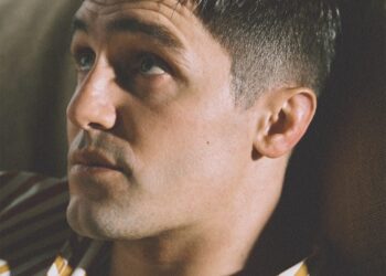 portrait of a person with a blurred face wearing a striped shirt